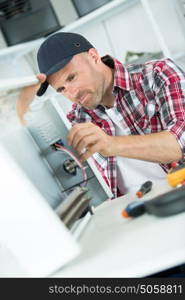 smily repairman fixing computer unit