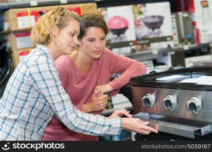 smily woman buying an oven in hypermarket