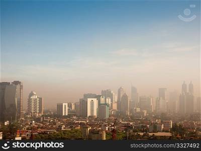Smog dome and dust during sunrise in a very polluted city - in this case Jakarta, Indonesia