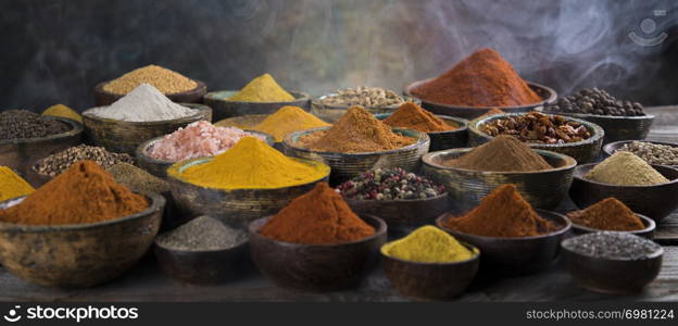 Smoke, Aromatic spices on wooden background