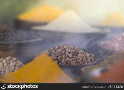 Smoke, Aromatic spices on wooden background