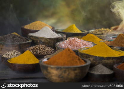 Smoke, Aromatic spices on wooden background