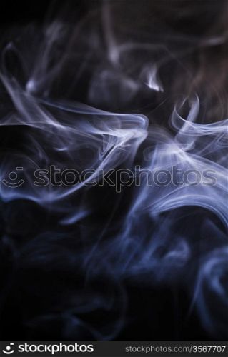 smoke curls on black