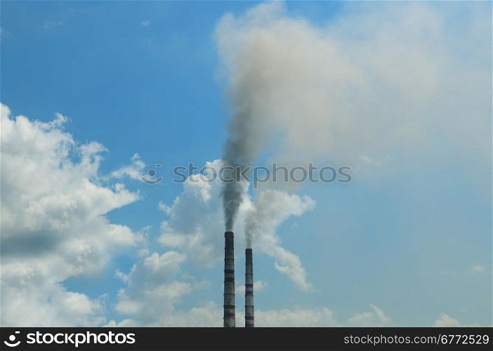 smoke from the pipes against the blue sky