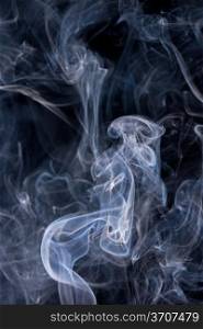 Smoke or Steam Rising against a Black Background