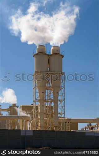 Smoke Stacks belching out pollution in a rural paper mill