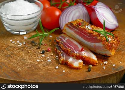 smoked bacon and vegetables on wooden table