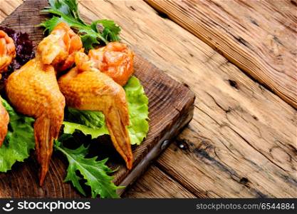 Smoked chicken wings. Smoked chicken wings and leaf salad. Fast food