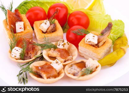 Smoked fish and feta cheese in pastries and fresh vegetables.