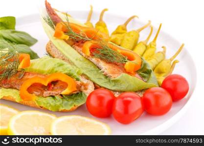 Smoked fish with fresh vegetables on plate.