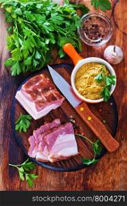 smoked lard with parsley on a table