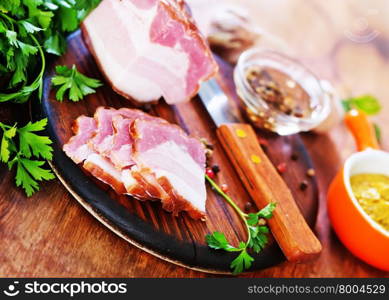 smoked lard with parsley on a table