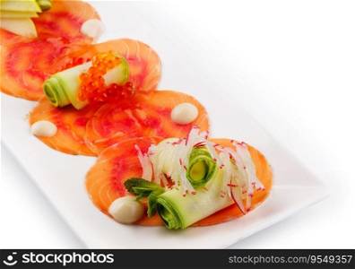 Smoked salmon fillet sliced and decorated with red caviar with zucchini