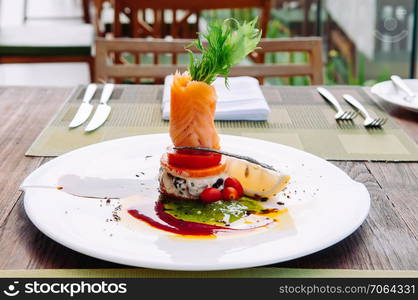 Smoked salmon salad with balsamic and pesto salad dressing, beautiful fine dining dish decoration