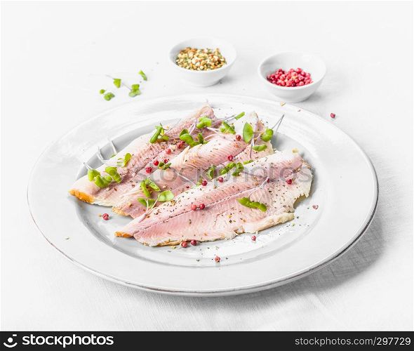 smoked trout fillet with pink pepper and fresh cress