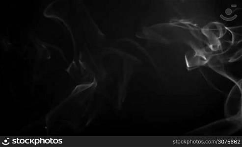 Smokes of cigarette against a black background