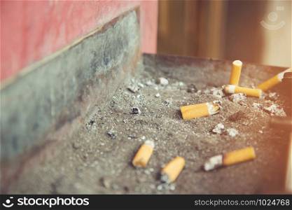 smoking a cigarette pulverize on the ashtray butts public , Quit smoking. Health concept.