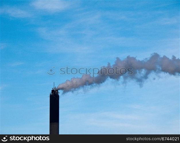 Smoking chimney. chimney smoke and blue sky in the background