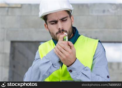 smoking cigarette at construction site