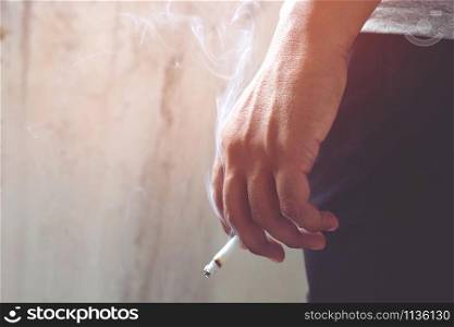 smoking Cigarettes tobacco close up in hand with a soft-focus. concept no quit Cigarettes are dangerous to health.