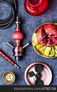 smoking hookah and dish with kiwi,pomegranate and lime