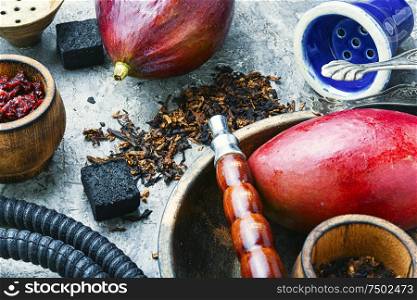 Smoking hookah.Details of shisha.Shisha with mango aroma of tobacco.. Arabic smoking hookah