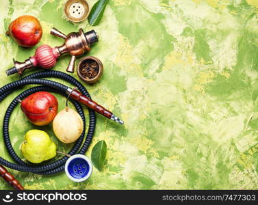 Smoking hookah.Details of Turkish kalian.Shisha with a fruity aroma of tobacco.Flat lay. Oriental smoking hookah