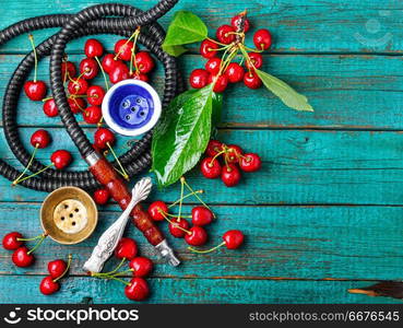 Smoking hookah.Fruit shisha.Eastern smoking nargile with cherry flavor.Hookah tobacco with cherry flavor. Hookah with tobacco taste of cherry