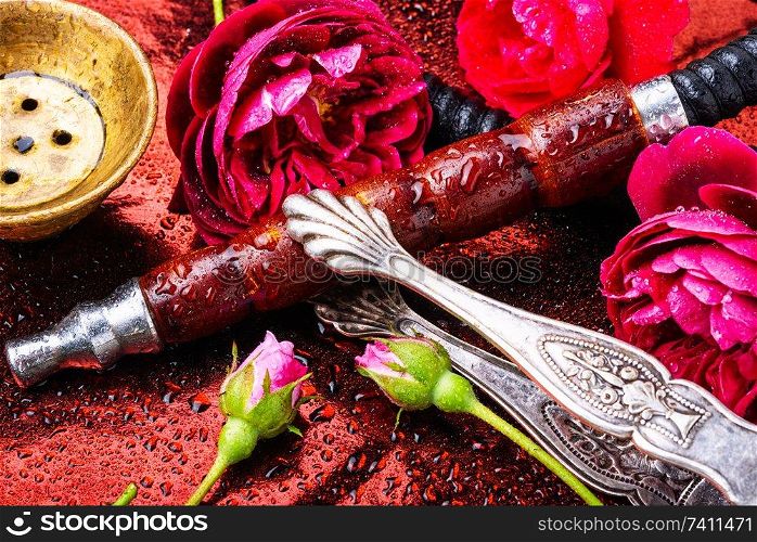 Smoking hookah with floral tobacco flavor.Hookah smoking. Oriental hookah with rose scent