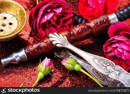 Smoking hookah with floral tobacco flavor.Hookah smoking. Oriental hookah with rose scent