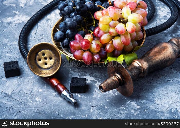 smoking hookah with grapes. smoked shisha with tobacco with taste of grapes