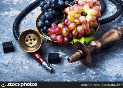 smoking hookah with grapes. smoked shisha with tobacco with taste of grapes