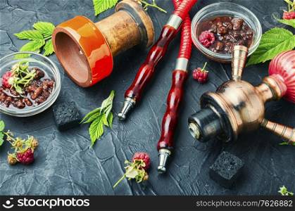 Smoking hookah with tobacco with the aroma of raspberry jam.Traditional shisha with raspberries. Hookah with of raspberry jam.