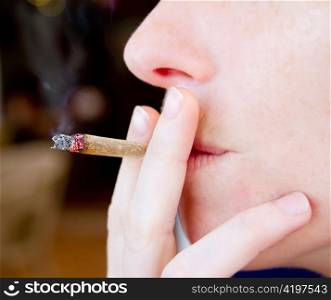 smoking joint closeup with smoke like unhealthy tobacco