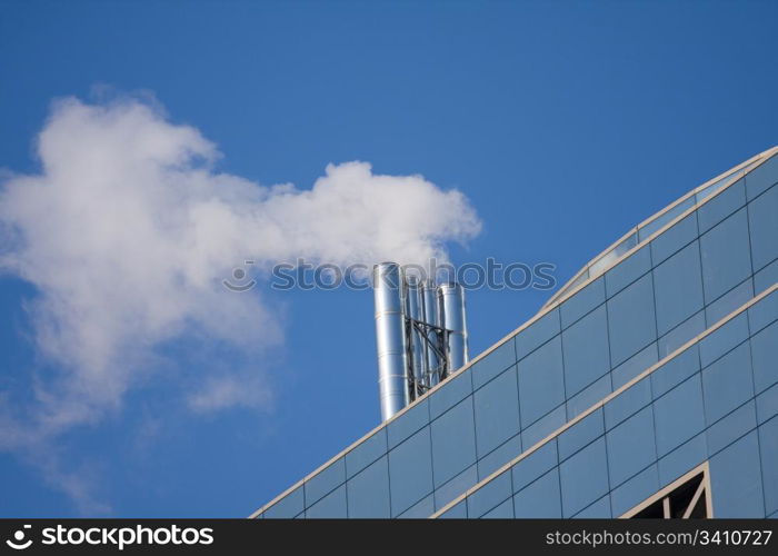 Smoking pipe on the roof of office building