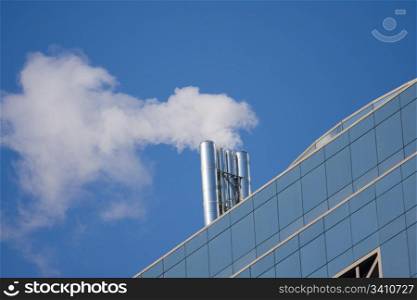 Smoking pipe on the roof of office building