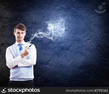 Smoking pipe. Young handsome businessman in fumes smoking pipe