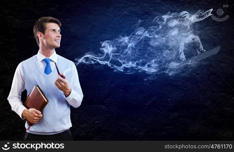 Smoking pipe. Young handsome businessman smoking pipe against black background