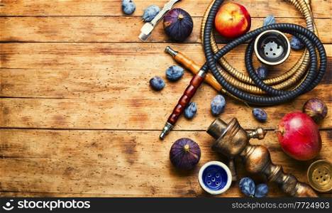 Smoking shisha with fruit flavor.Oriental hookah on fruit tobacco.Space for text. Traditional smoking hookah,space for text
