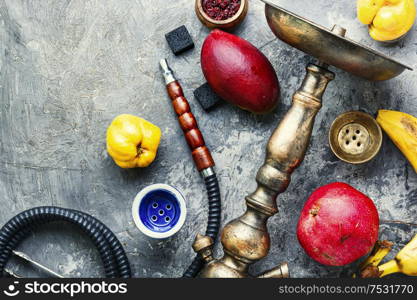 Smoking shisha with fruit tobacco flavor.Details of Turkish hookah.Egyptian kalian. Oriental fruit smoking hookah.