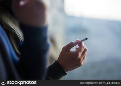 smoking, substance abuse, addiction, people and bad habits concept - close up of male hand with cigarette