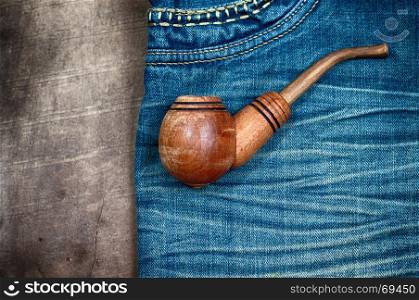 smoking wooden pipe on blue dzhinskah worn, vintage toning