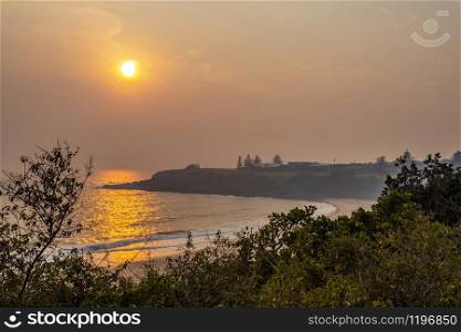 Smoky sunrise over Kendalls Beach in Kiama, New South Wales, during the bushfire season of December 2019