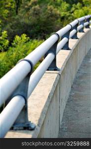 Smooth curving bridge handrail.