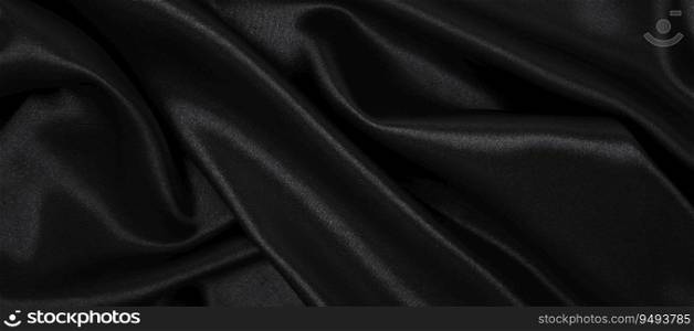 Smooth elegant black silk or satin luxury cloth texture can use as abstract background. Luxurious background design