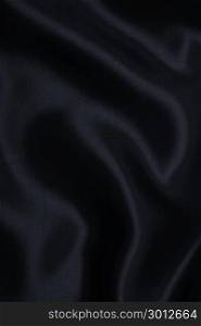 Smooth elegant black silk or satin texture can use as abstract background. Luxurious background design