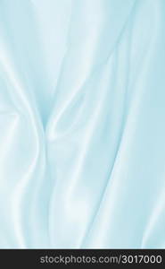 Smooth elegant blue silk or satin luxury cloth texture can use as abstract background. Luxurious background design