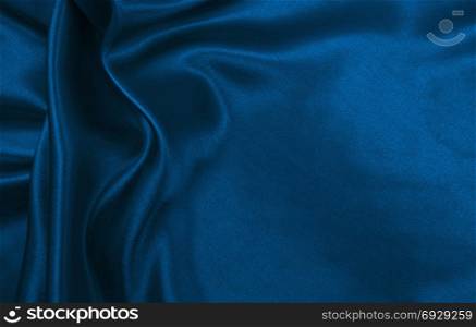Smooth elegant blue silk or satin luxury cloth texture can use as abstract background. Luxurious Christmas background or New Year background design