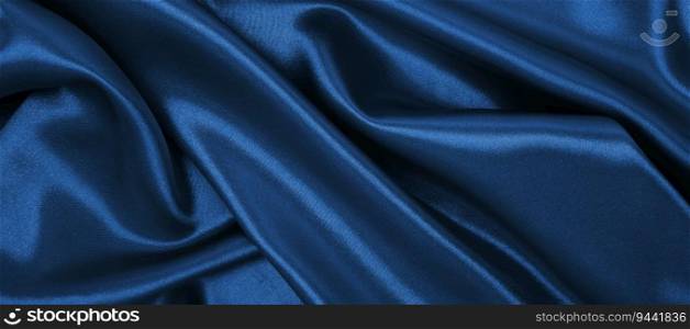 Smooth elegant blue silk or satin luxury cloth texture can use as abstract background. Luxurious Christmas background or New Year background design  