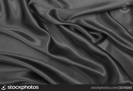 Smooth elegant dark grey silk or satin texture can use as abstract background. Luxurious background design